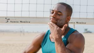 A man under the sun after applying sunscreen generously